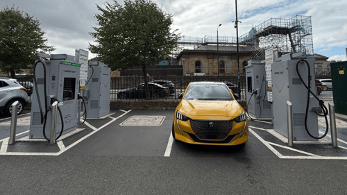 Yellow electric vehicle charging at InstaVolt ultra-rapid chargers in Pavilion Square Car Park, Scarborough