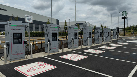 Ultra-rapid InstaVolt EV chargers at Bell Farm Way, Kempston, located next to a Starbucks and Carlton industrial facility.