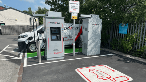 InstaVolt ultra-rapid EV chargers in use at Coppull Spendmore Lane location with branded van in background.