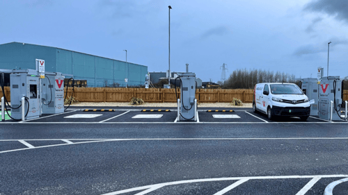 InstaVolt ultra-rapid EV charging bays in a McDonald’s car park with marked spaces and industrial buildings in the background.