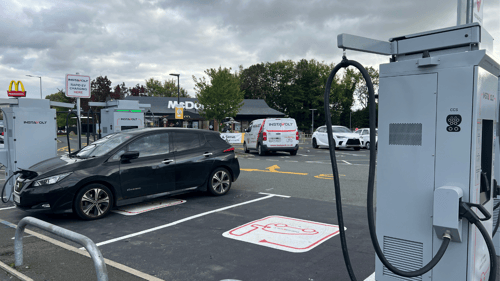 Nissan Leaf charging at InstaVolt ultra rapid EV chargers outside McDonald's Whitefield, Manchester.
