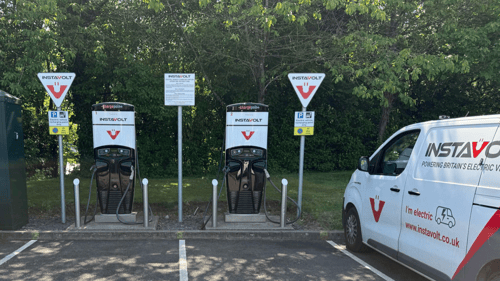 InstaVolt rapid EV chargers with branded van parked at Bannatyne Health Club & Spa in Solihull, surrounded by greenery.