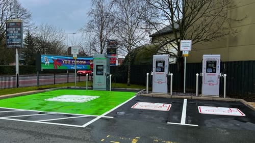 InstaVolt ultra rapid EV chargers at McDonald's, Portsmouth Road, PO6. Charging bays with bright green markings and three charging units available. Esso petrol station visible in the background.