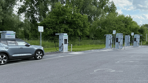 InstaVolt ultra rapid EV chargers at Cobbs Farm Shop near Hungerford, with a parked electric vehicle and green countryside in the background.