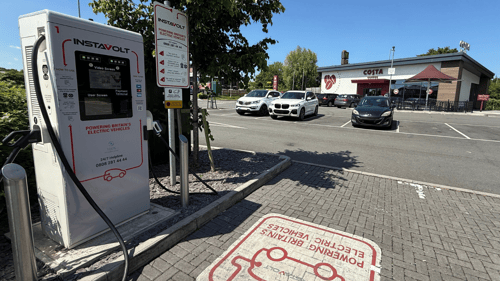 InstaVolt ultra rapid EV charger in front of Costa Coffee Ilminster, with parked vehicles and McDonald’s signage visible in the background.