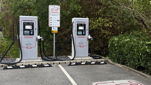 InstaVolt rapid EV charging station with two chargers in a leafy car park