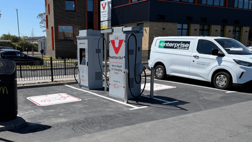 InstaVolt ultra rapid EV charging station with dedicated parking bays beside a modern roadside retail and business location