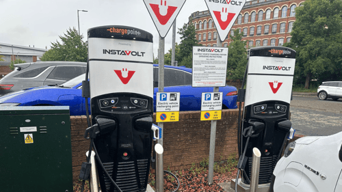 Two InstaVolt rapid EV chargers at Charleston Service Station in Paisley, with vehicles actively charging.