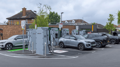 InstaVolt electric vehicle charging bay in Shaftesbury Harrow with multiple cars charging outside a McDonald’s restaurant.