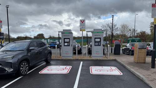 EV chargers at InstaVolt charging station with parked electric vehicles on a cloudy day near McDonald's Weston-Super-Mare.