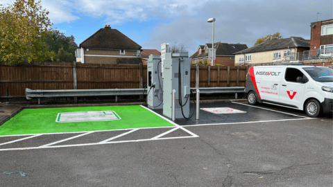 Ultra rapid EV chargers by InstaVolt in a quiet parking area, with clear green and white markings for electric vehicle parking