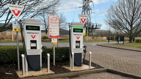 Two InstaVolt electric vehicle charging stations with clear signage, located in a landscaped car park.