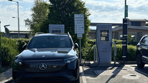 Electric vehicle charging at InstaVolt ultra rapid chargers near Costa at Solstice Park, Amesbury, with a Mercedes EQ parked during charging.