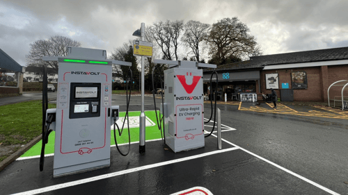 InstaVolt ultra-rapid EV chargers outside Co-op Llanidloes on a cloudy day, with convenient access for electric vehicle drivers.