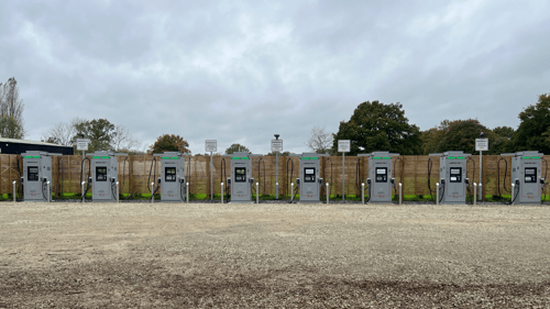 Six InstaVolt chargers positioned in a row at Frankies Farm Shop, providing ultra-fast EV charging access in a spacious parking area.