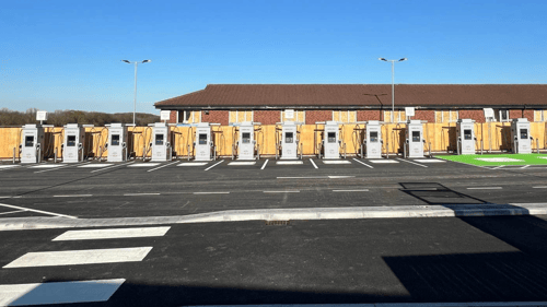 InstaVolt ultra rapid EV charging bays at a new site, with ample parking and clear access markings, located near a service building.