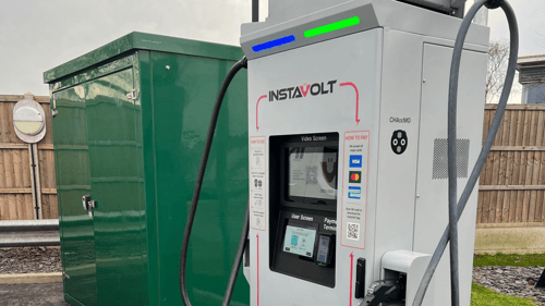 Close-up of InstaVolt ultra rapid EV charging unit showing user screen and payment terminal.