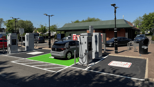 InstaVolt ultra rapid EV chargers located at Gower Street, Newtown, Wigan, WN5 9AD, with a grey electric vehicle actively charging beside a McDonald's restaurant.