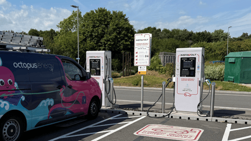 InstaVolt ultra rapid EV chargers in use beside an Octopus Energy van at a UK charging site.