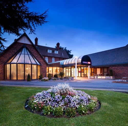 Exterior shot of the front of the mercure hull grange park hotel at night.