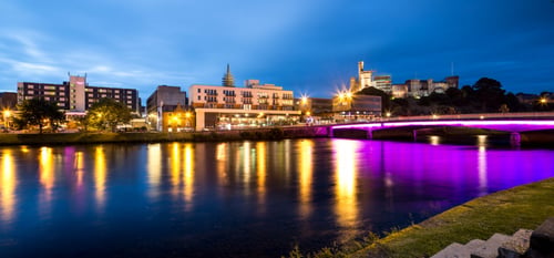 Night time shot of front of Mercure Hotel Inverness with River Ness in foreground