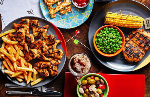 Ten chicken wings and PERi chips, Butterfly chicken with corn on the cob and macho peas with a bowl of olives and a side of Halloumi sticks